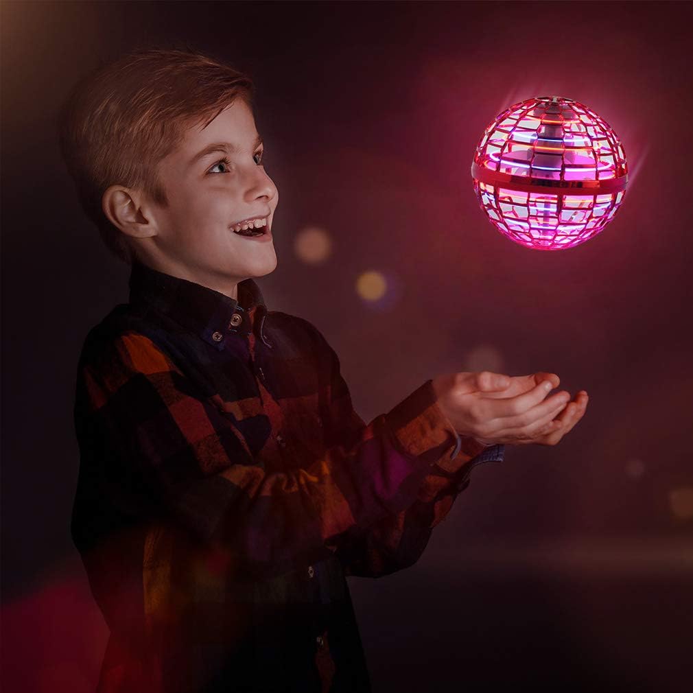 Boy playing with Galactic Flying Spinner which is hovering above his hands.