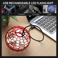 Rechargeable flying orb toy connected to a laptop via USB cable. 