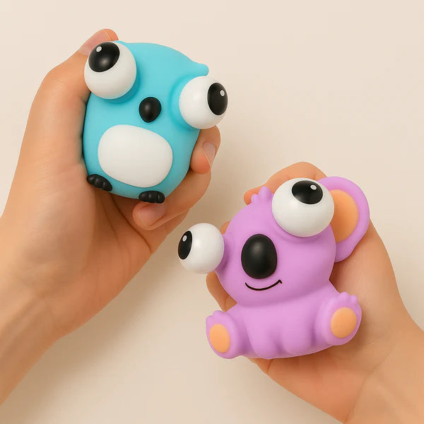 Hands holding silicone owl and koala toys featured in the GoBag Buddies set.