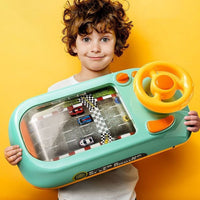Boy holding a Highway Hero toy that features a steering wheel, buttons, and carousel with moving cars.