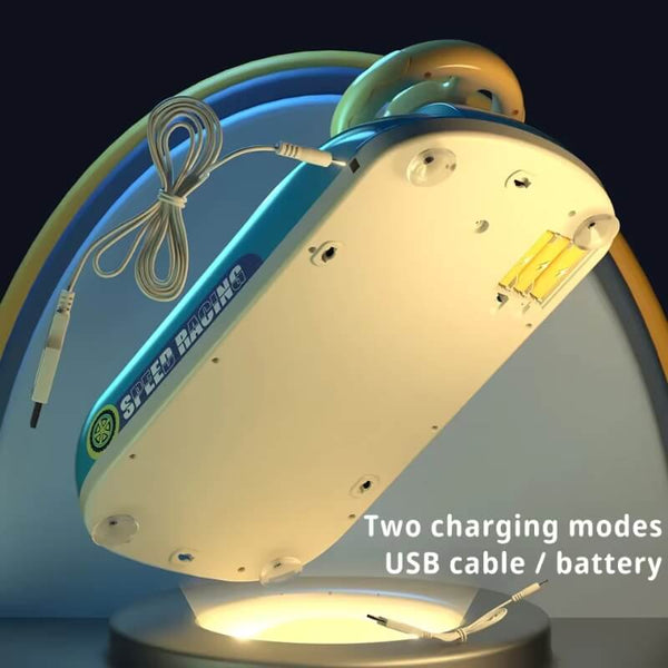 Bottom view of the Highway Star toy steering wheel game, showing two charging modes: USB cable and battery. The image highlights the battery compartment and USB charging port, emphasizing flexible power options. The toy features suction cups for secure attachment to surfaces. 