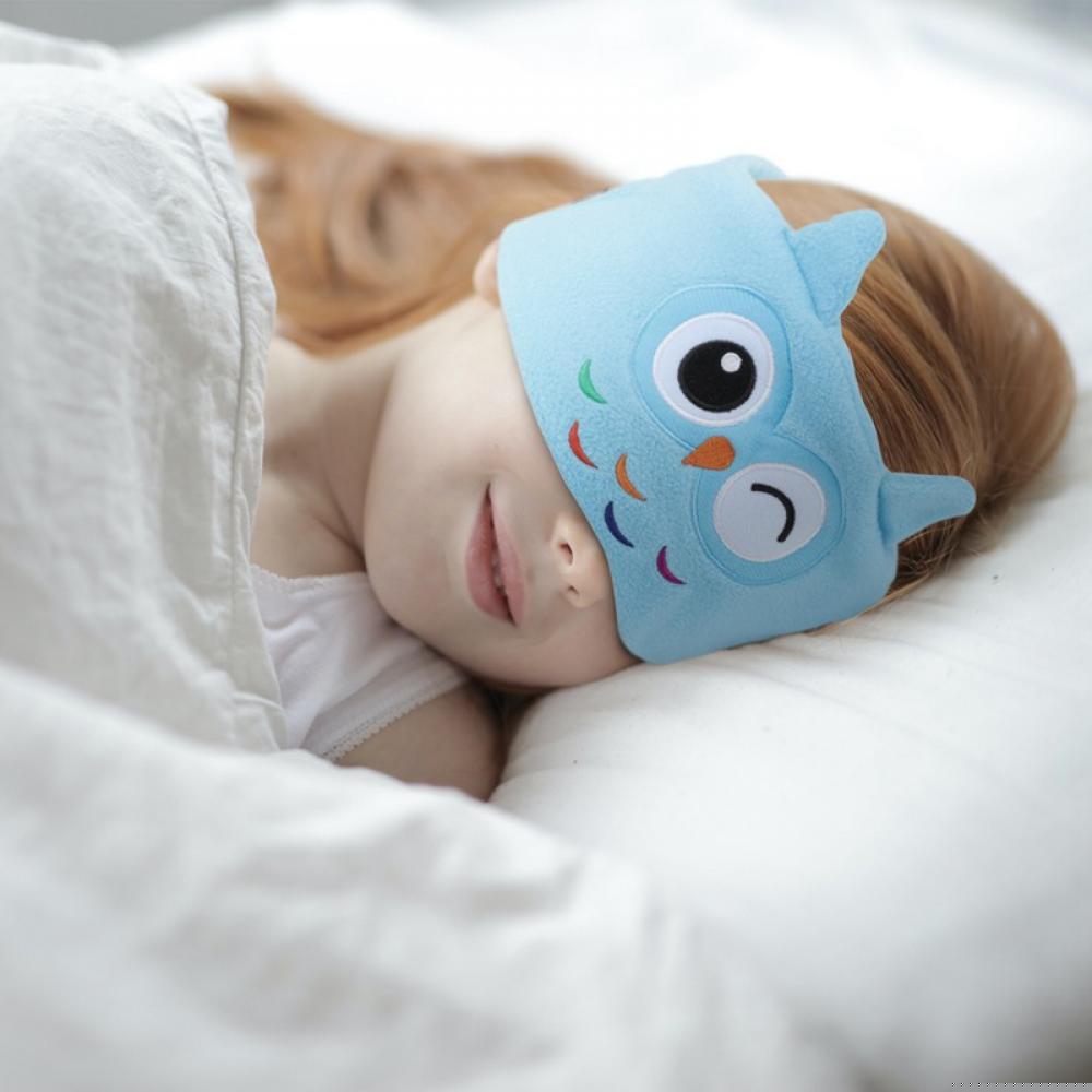 Girl sleeping with SnuggleSounds heaphones on her head.
