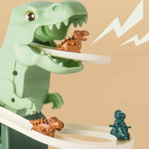 Close-up of a green T-Rex toy with an open mouth. Small dinosaur figures ride along curved tracks emerging from the dinosaur’s mouth.